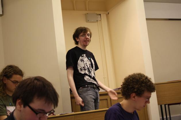 Tom delivers the treasurer's report.