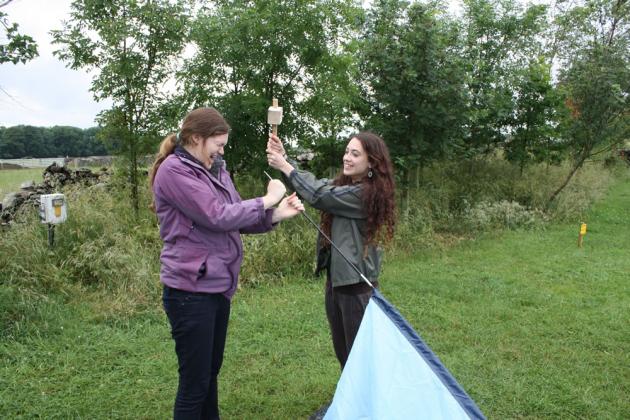 Rosie beating Nicola with a mallet.