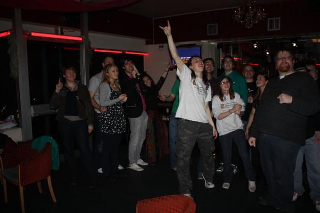 Everyone gets up to sing.