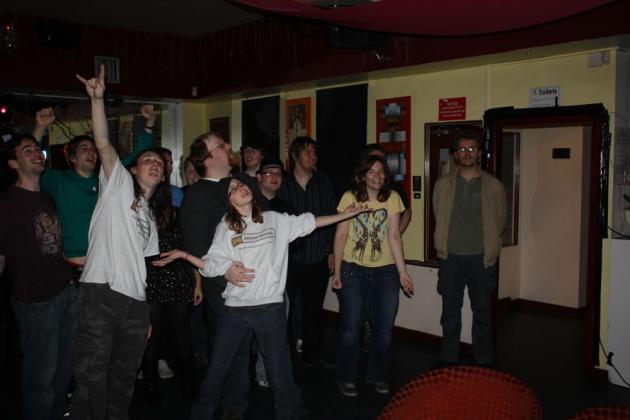 Everyone gets up to sing.