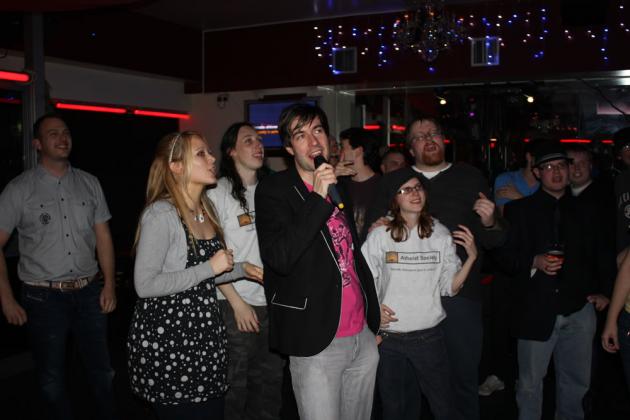 Everyone gets up to sing.