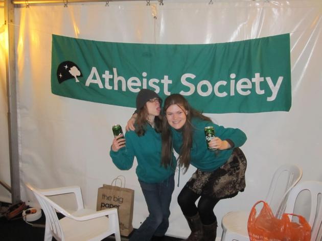 Lil and Nicola in front of the society banner.