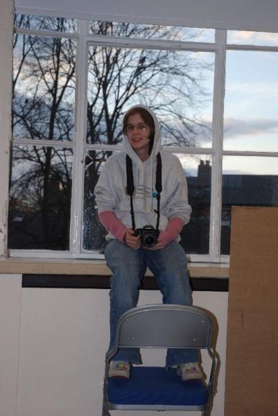 Liz sitting on the window taking photos.