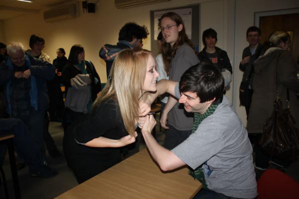Rich signs Kate's breast.