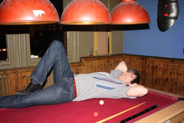 Rich does a photoshoot on the pool table.